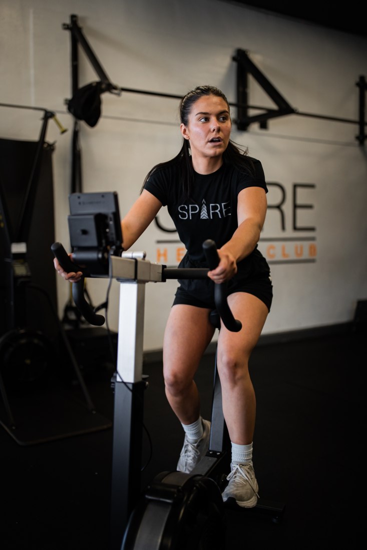 Athlete training on an exercise bike at Spire
